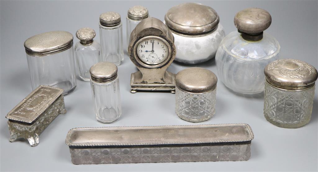An Edwardian silver mounted balloon shaped timepiece, 11.5cm and sundry mounted toilet jars.